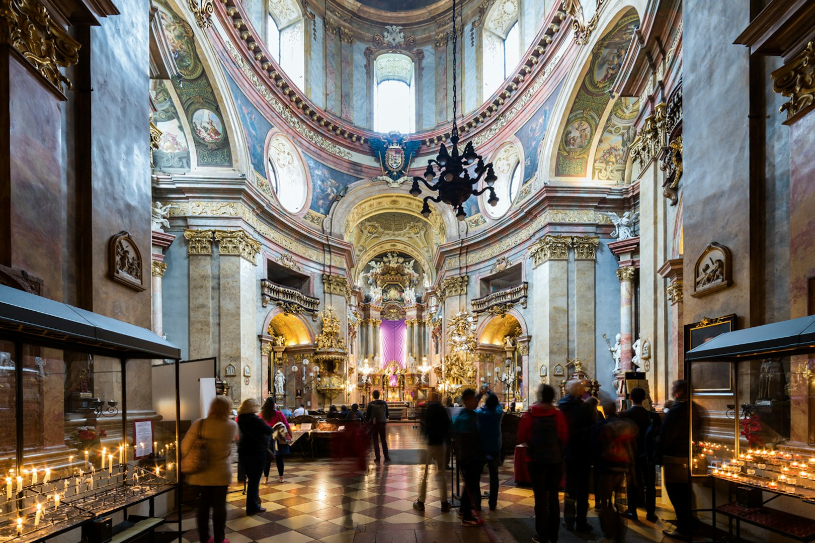 St. Peter's Church interior with visitors and lit candles during Christmas concert.