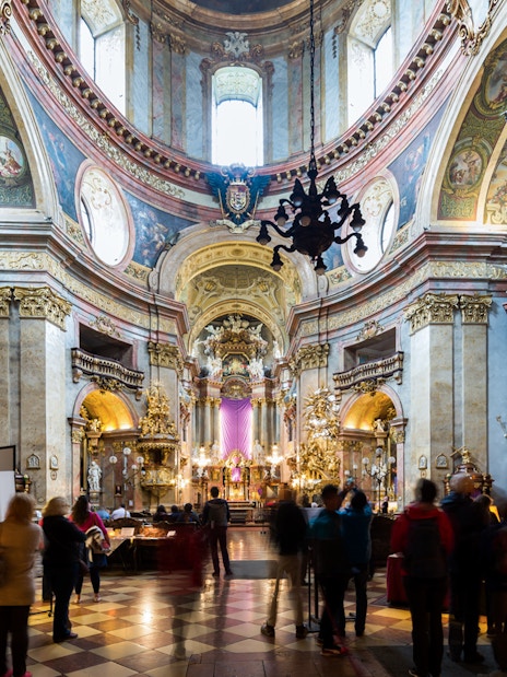 St. Peter's Church interior with visitors and lit candles during Christmas concert.