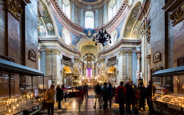 St. Peter's Church interior with visitors and lit candles during Christmas concert.