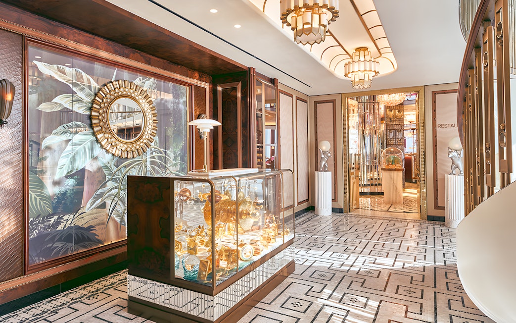 Entrance to At.Mosphere restaurant, Burj Khalifa, featuring elegant decor and mirrored walls.