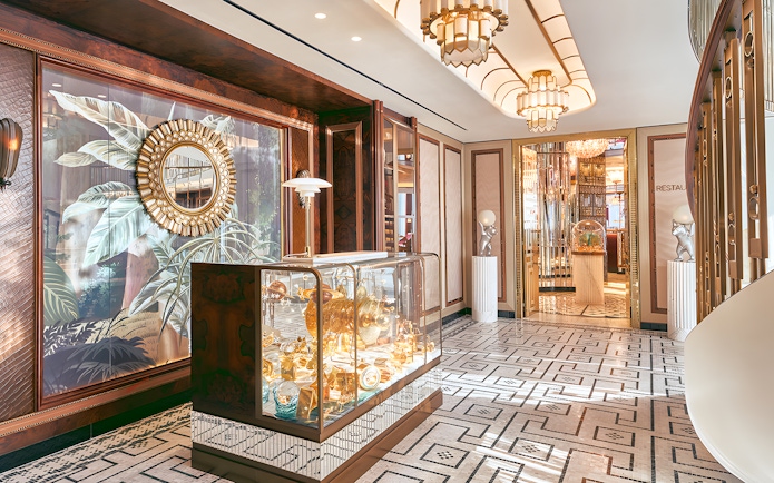 Entrance to At.Mosphere restaurant, Burj Khalifa, featuring elegant decor and mirrored walls.
