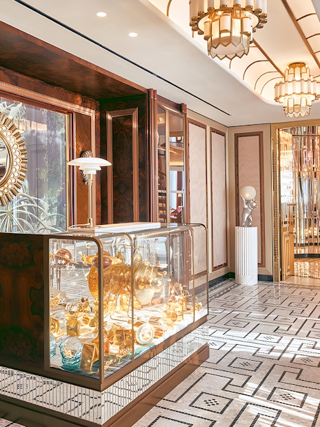 Entrance to At.Mosphere restaurant, Burj Khalifa, featuring elegant decor and mirrored walls.