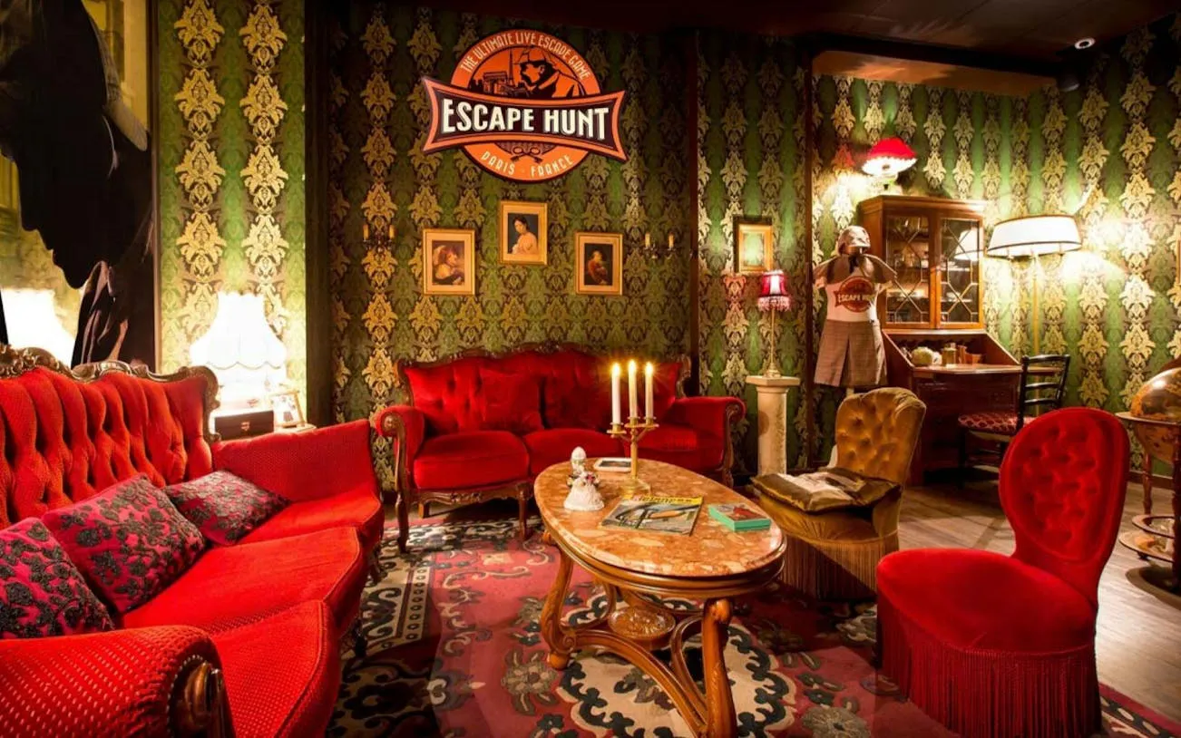 Escape room with vintage decor and red sofas in Dubai's Aladdin & The Magic Vault experience.