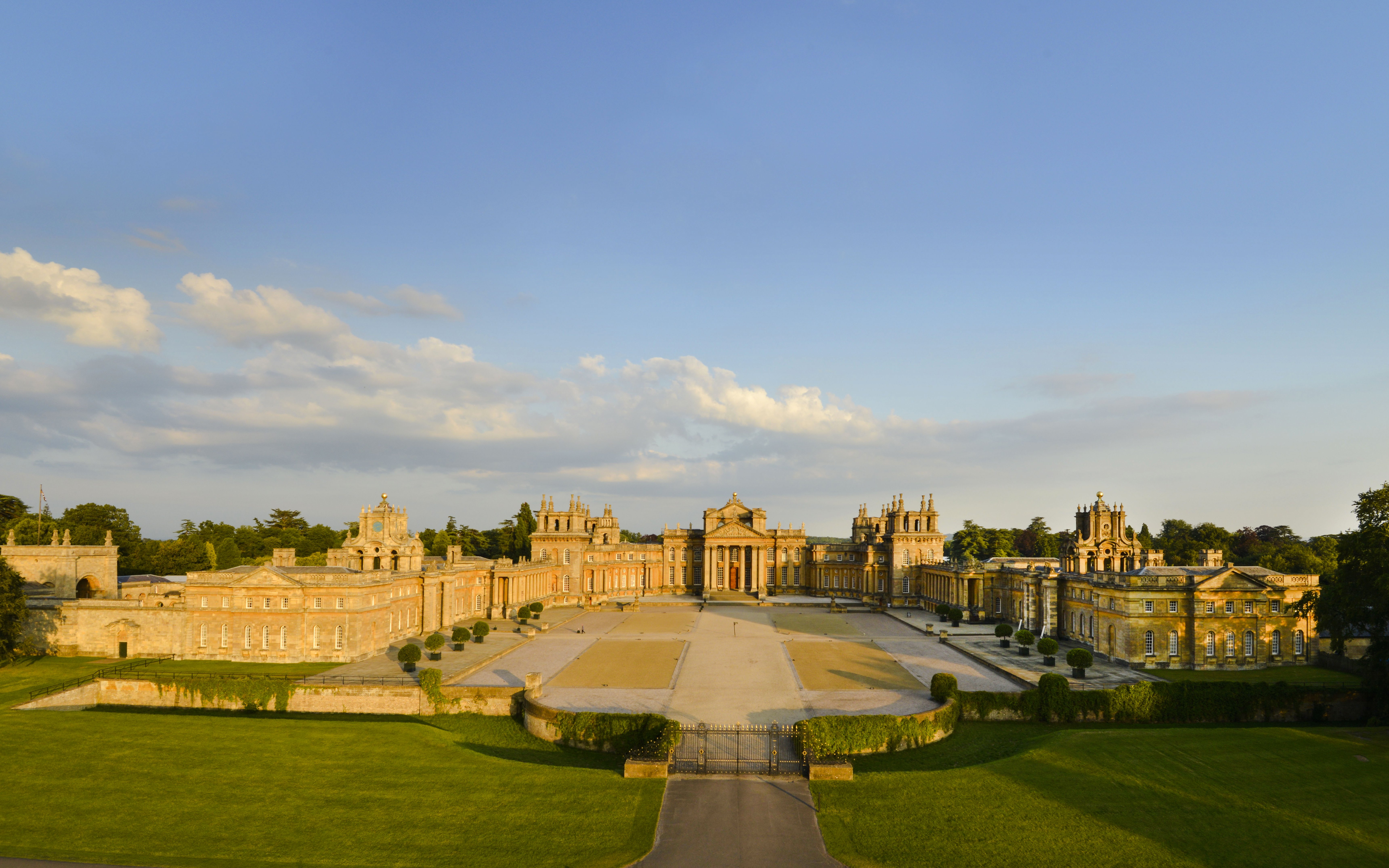 Aerial view of Blenheim Palace in Oxfordshire, England, showcasing its grand architecture and gardens.