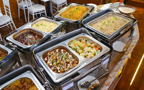 Buffet dinner spread on a Dubai Marina dhow cruise with various dishes.