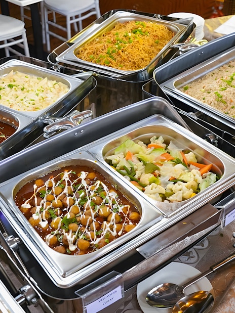 Buffet dinner spread on a Dubai Marina dhow cruise with various dishes.