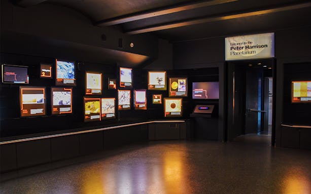 Royal Observatory Planetarium Gallery with illuminated displays and entrance sign.