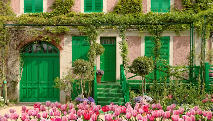 House of Monet in Paris with vibrant garden and lily pond reflecting the artist's inspiration.