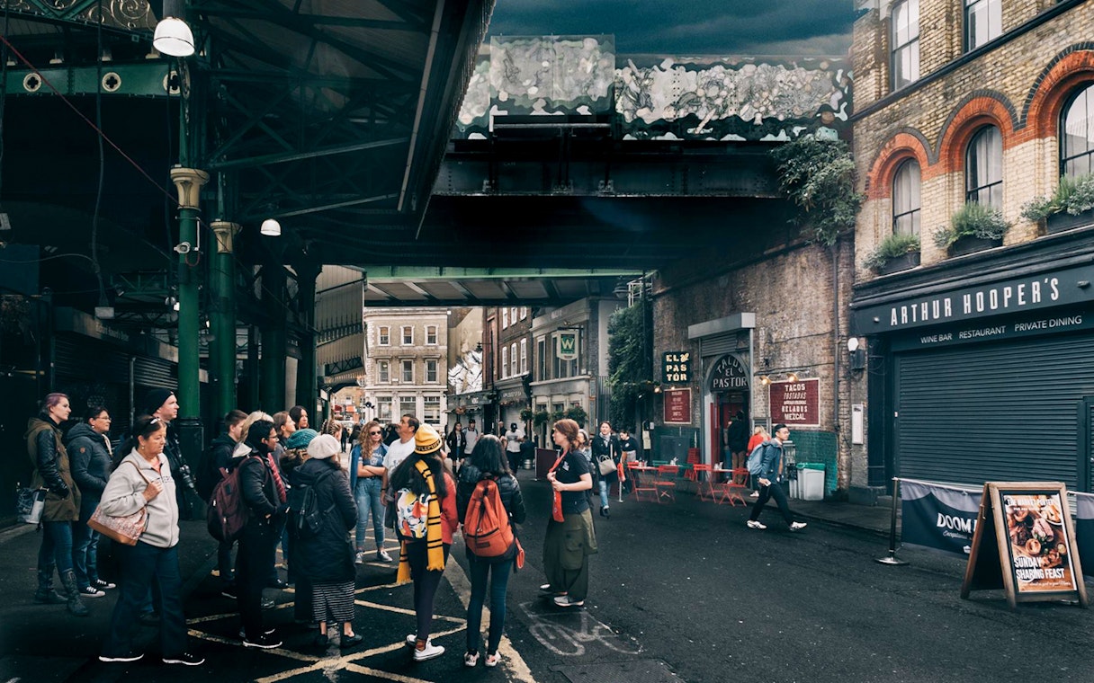 Group of tourists at Borough Market, a Harry Potter film location in London.