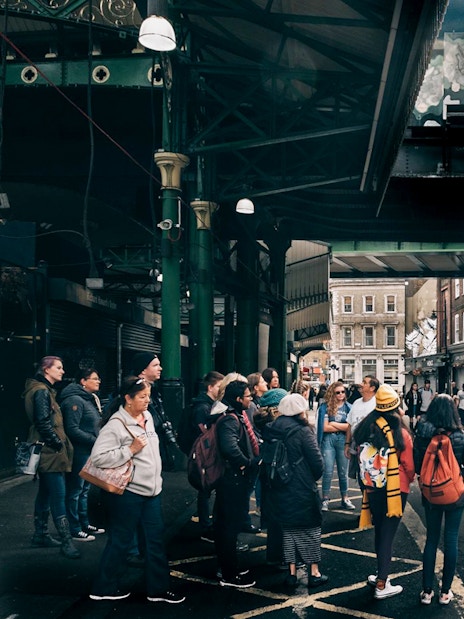 Group of tourists at Borough Market, a Harry Potter film location in London.
