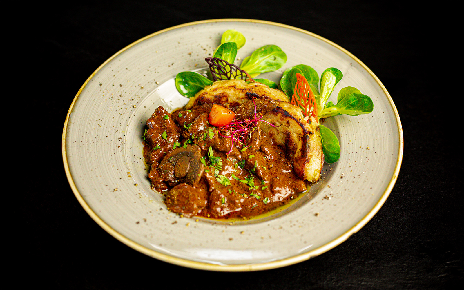 Hungarian goulash served on a Budapest dinner cruise with folk show.