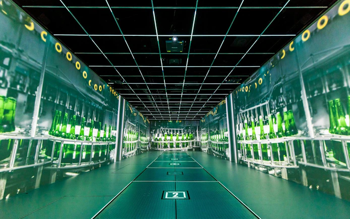 Heineken Experience interactive exhibit with green bottles on display in Amsterdam.