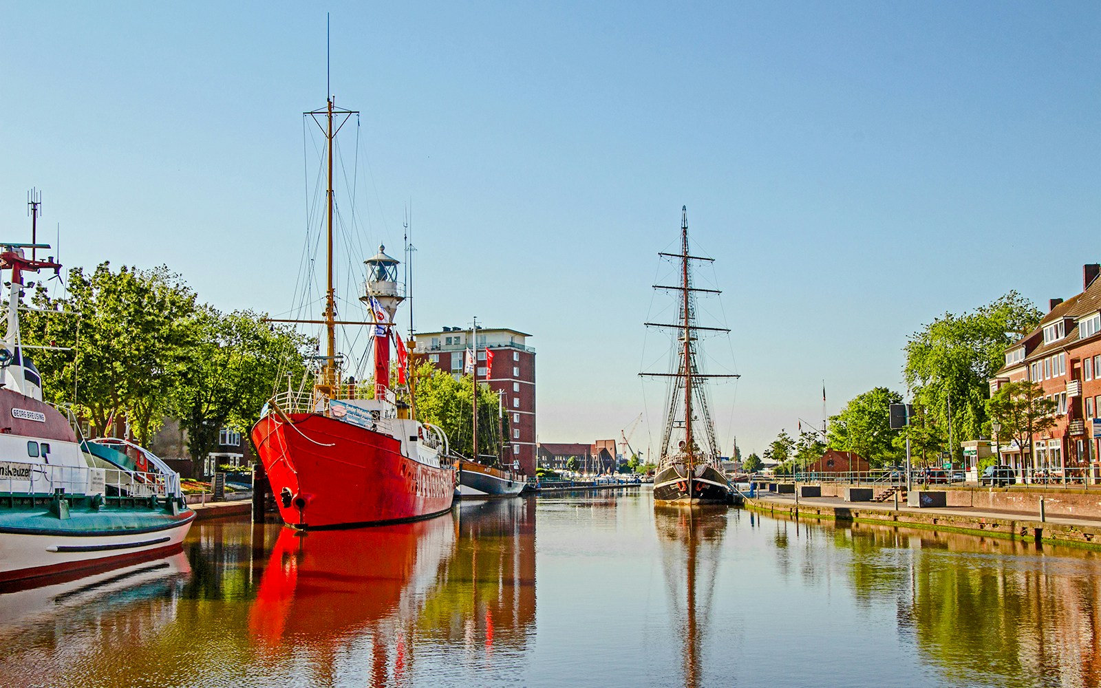 Historic ships docked along a canal in Rotterdam near Delftse Poort.