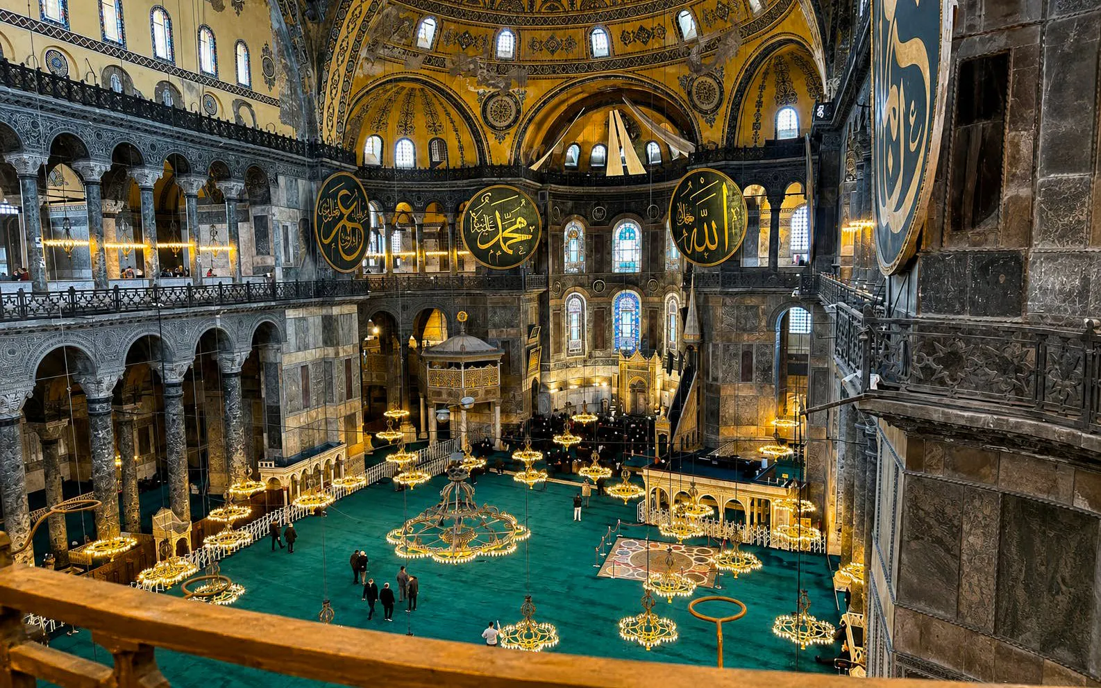 Interior view of Hagia Sophia's grand dome and ornate chandeliers, Istanbul.