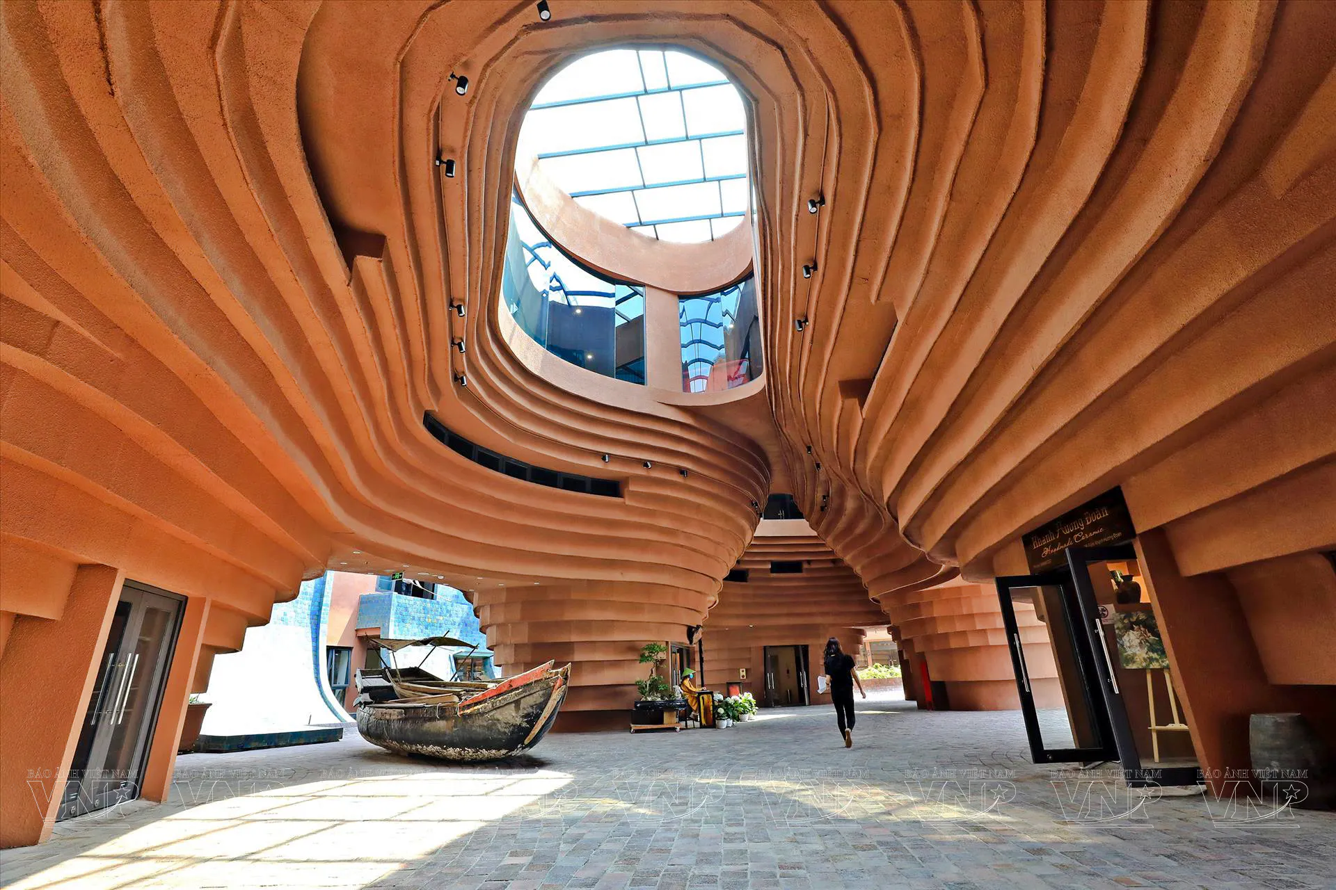 Curved architectural interior with boat display at Pottery Village, Ha Noi.