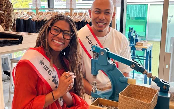 Couple crafting denim jeans at Harajuku workshop in Tokyo.