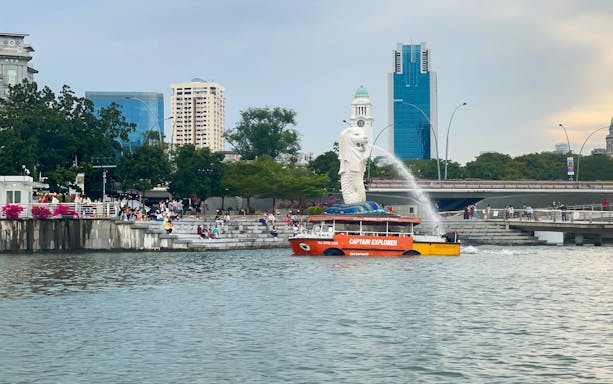 Tour boat near Merlion Park, Singapore, with city skyline in the background.