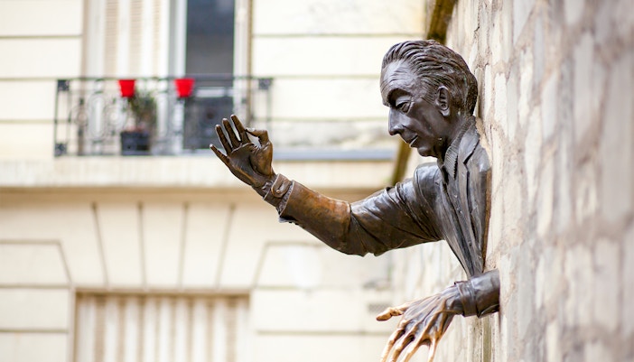 Sculpture of a man emerging from a wall in Montmartre, Paris.