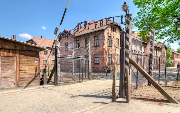 Auschwitz main gate with “Arbeit Macht Frei” sign, Poland.