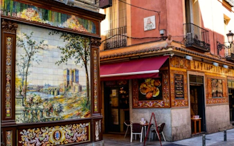 Colorful tiled facade on Calle de Álvarez Gato, Madrid, part of the Escape the Inquisition city exploration game.