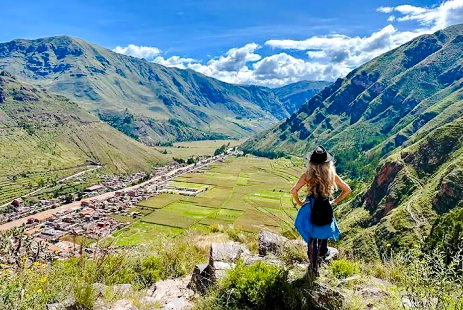 Traveler overlooking Sacred Valley landscape on guided tour from Cusco, Peru.