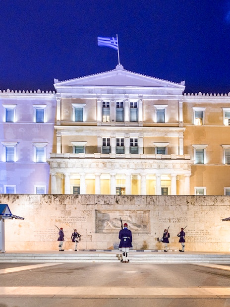 Greek Parliament building at Syntagma Square, Athens, with ceremonial guards.