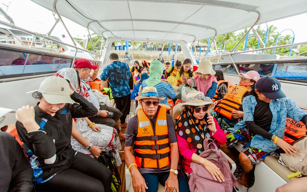 Tourists on a speedboat wearing life jackets during Surin Islands tour in Thailand.