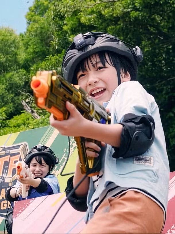 Children playing with toy guns at Junglia Okinawa theme park.
