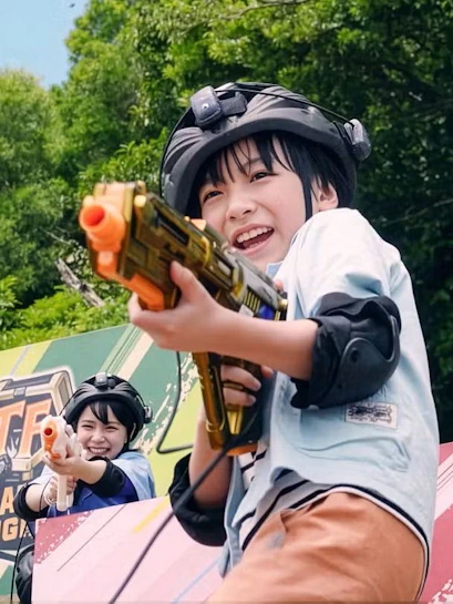 Children playing with toy guns at Junglia Okinawa theme park.