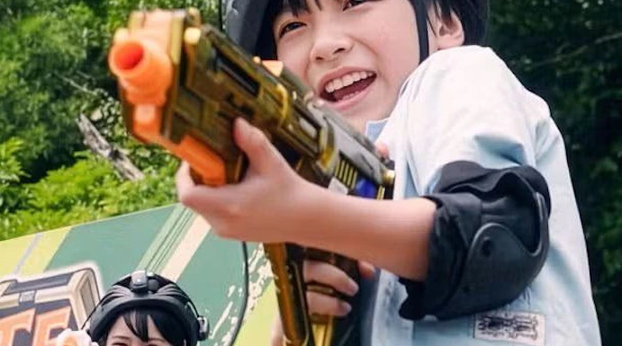Children playing with toy guns at Junglia Okinawa theme park.