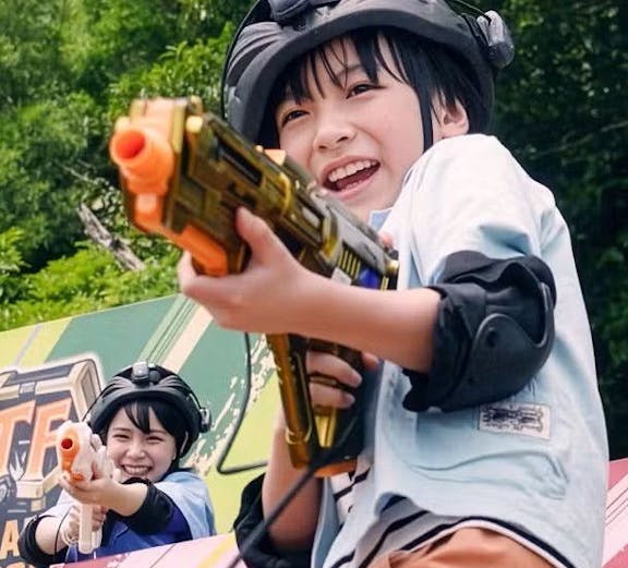 Children playing with toy guns at Junglia Okinawa theme park.