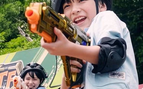 Children playing with toy guns at Junglia Okinawa theme park.
