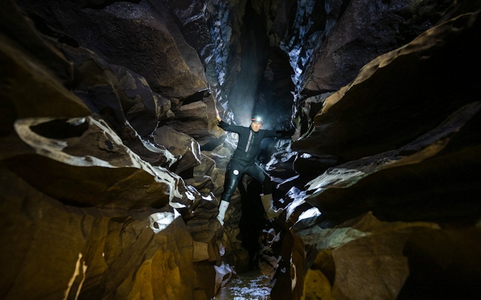 Explorer in Okohua Glowworm Cave during Waitomo Experience tour.