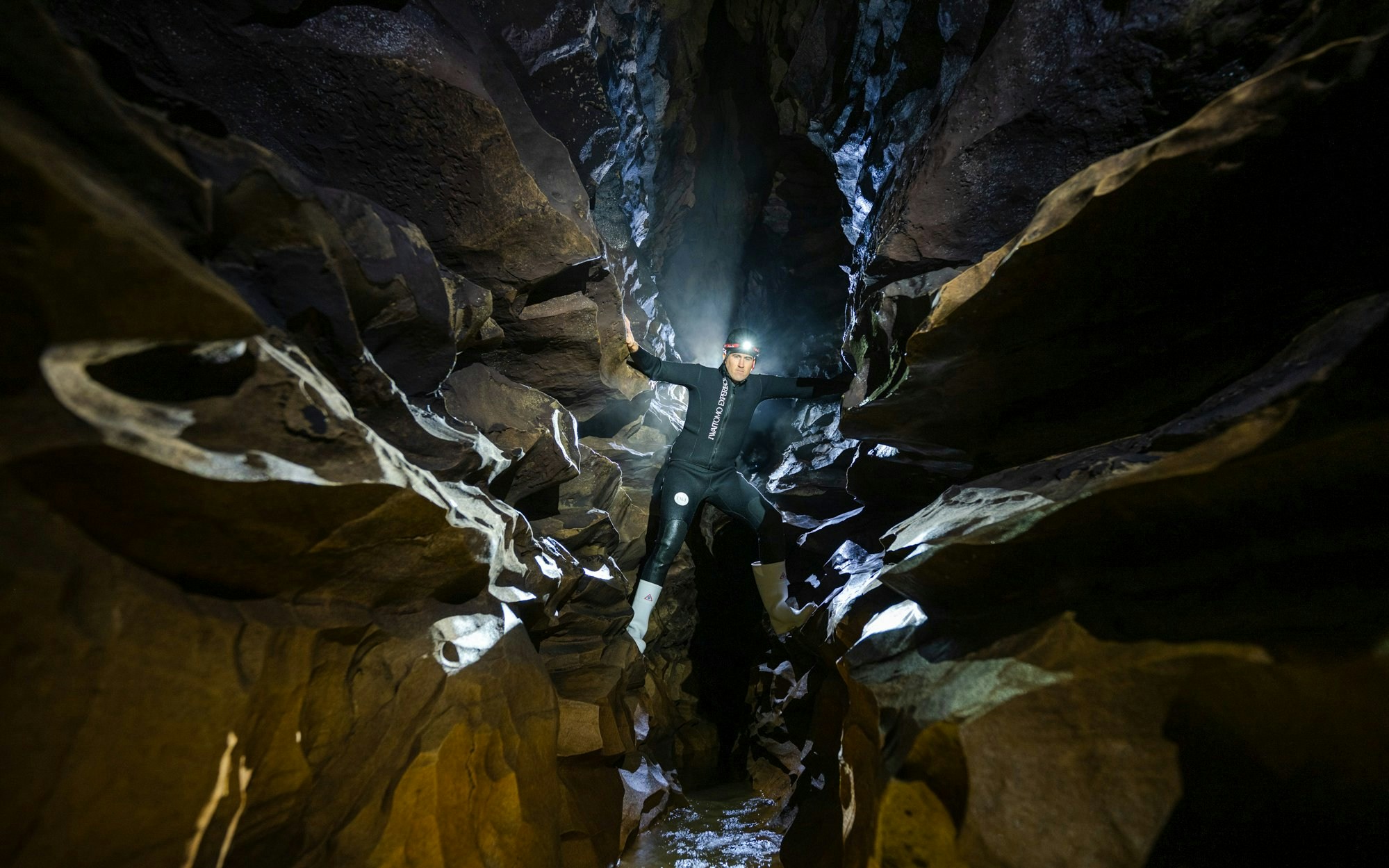 Explorer in Okohua Glowworm Cave during Waitomo Experience tour.