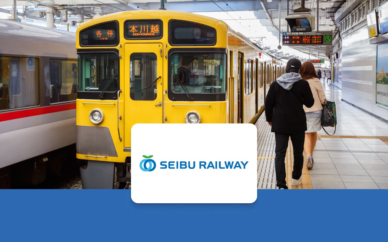 Yellow Seibu Railway train at station platform, Japan.