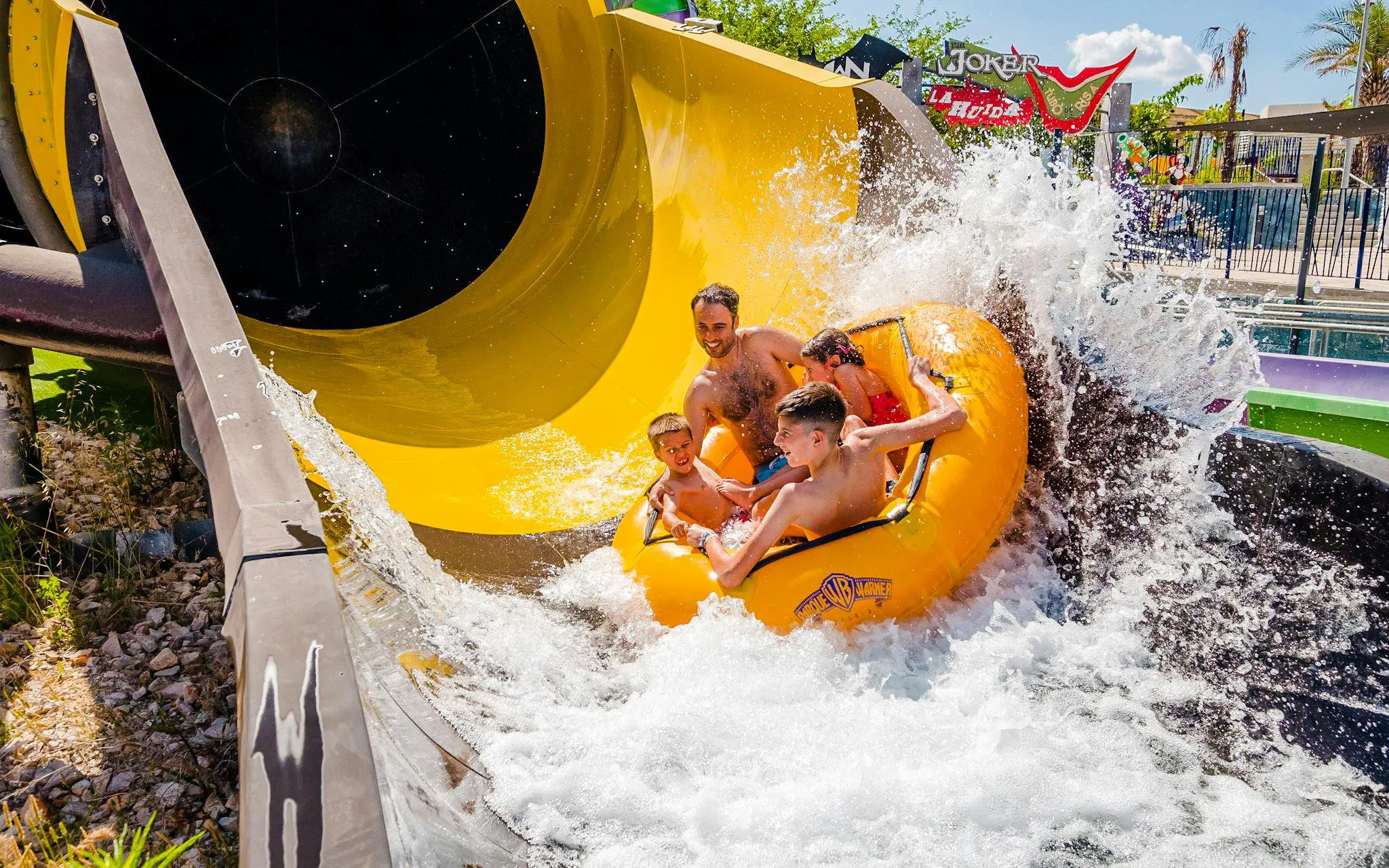 Family enjoying water slide at Parque Warner Beach.