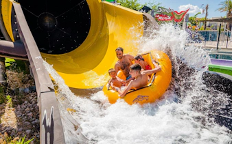 Family enjoying water slide at Parque Warner Beach.