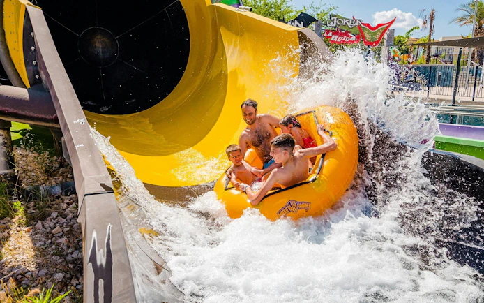 Family enjoying water slide at Parque Warner Beach.