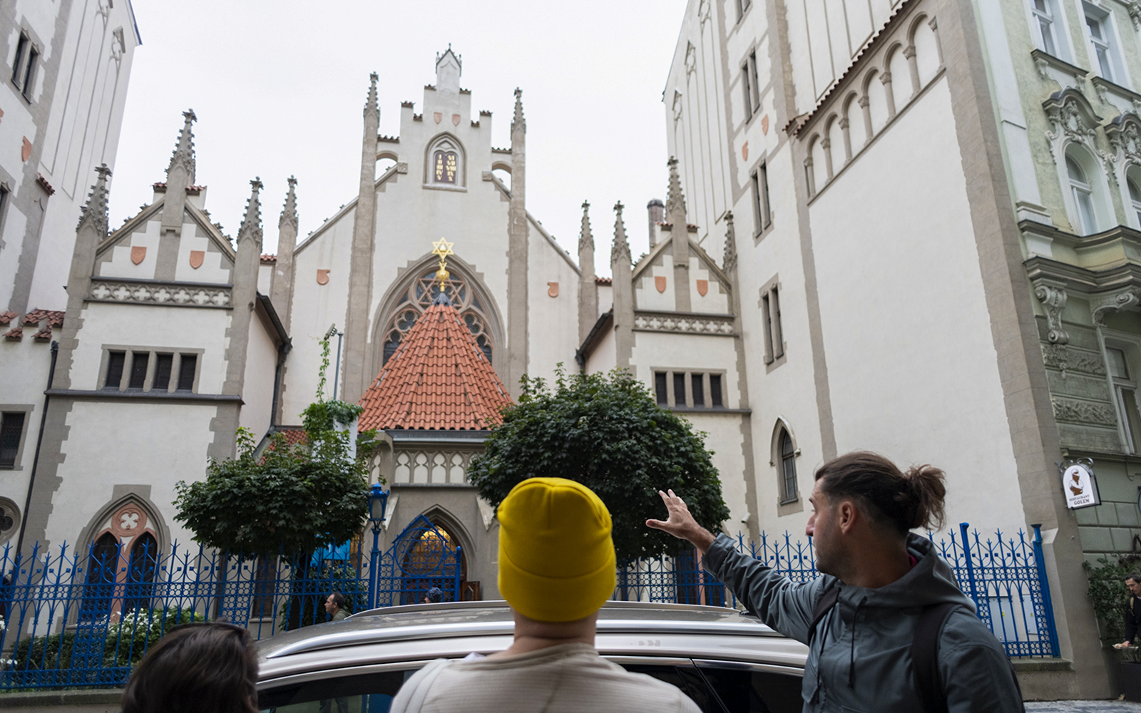Tour guide showing guests the historic Jewish Quarter in Prague.