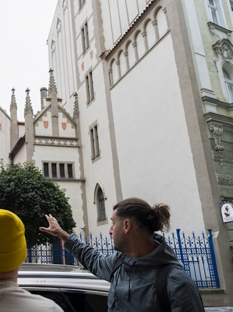 Tour guide showing guests the historic Jewish Quarter in Prague.