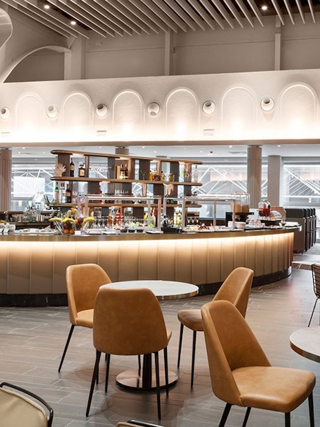 Plaza Premium Lounge seating area with bar, Terminal 1, Fiumicino Airport.