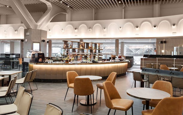 Plaza Premium Lounge seating area with bar, Terminal 1, Fiumicino Airport.