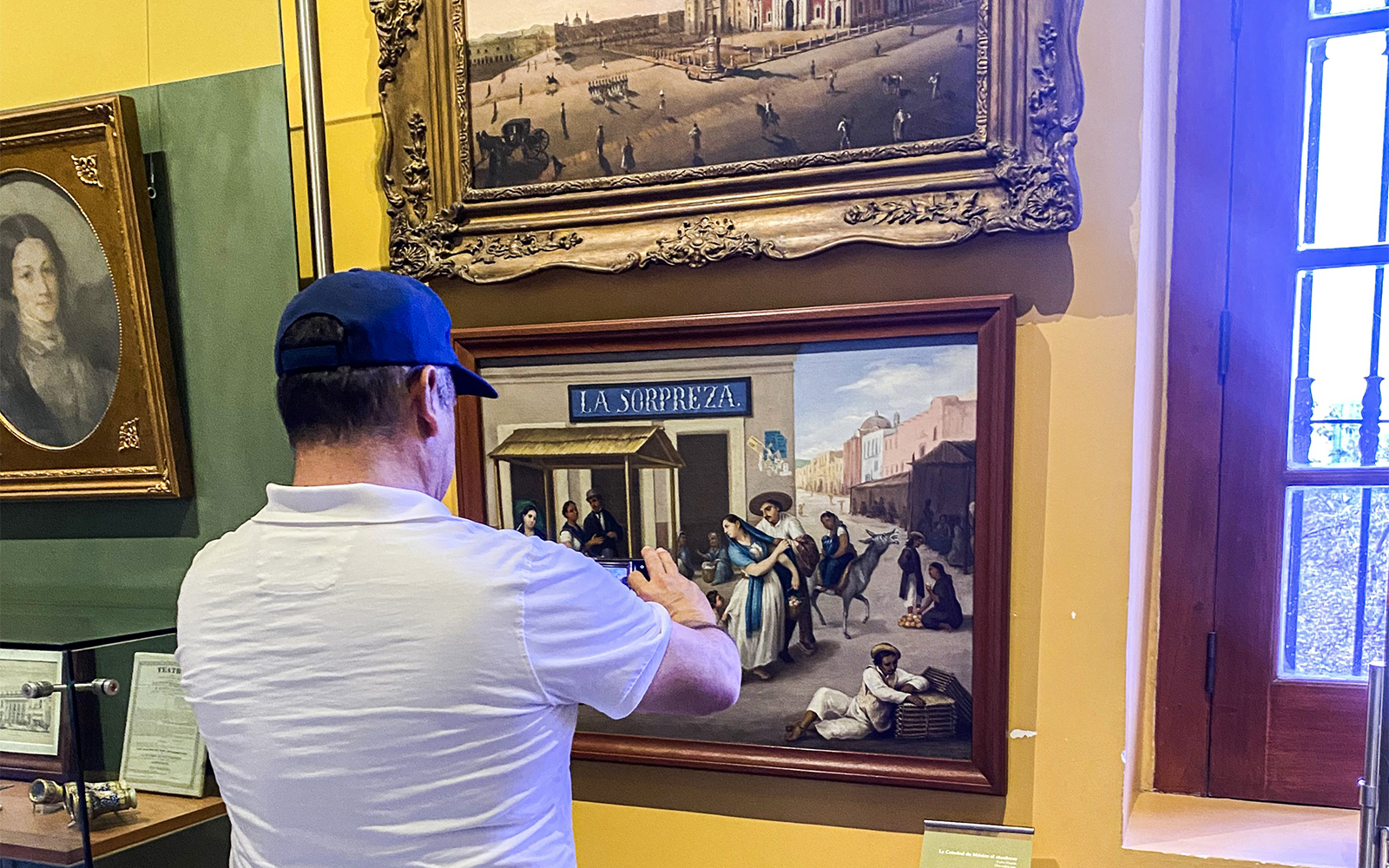 Chapultepec Castle in Mexico City with tourists exploring the historic architecture and lush surrounding gardens.
