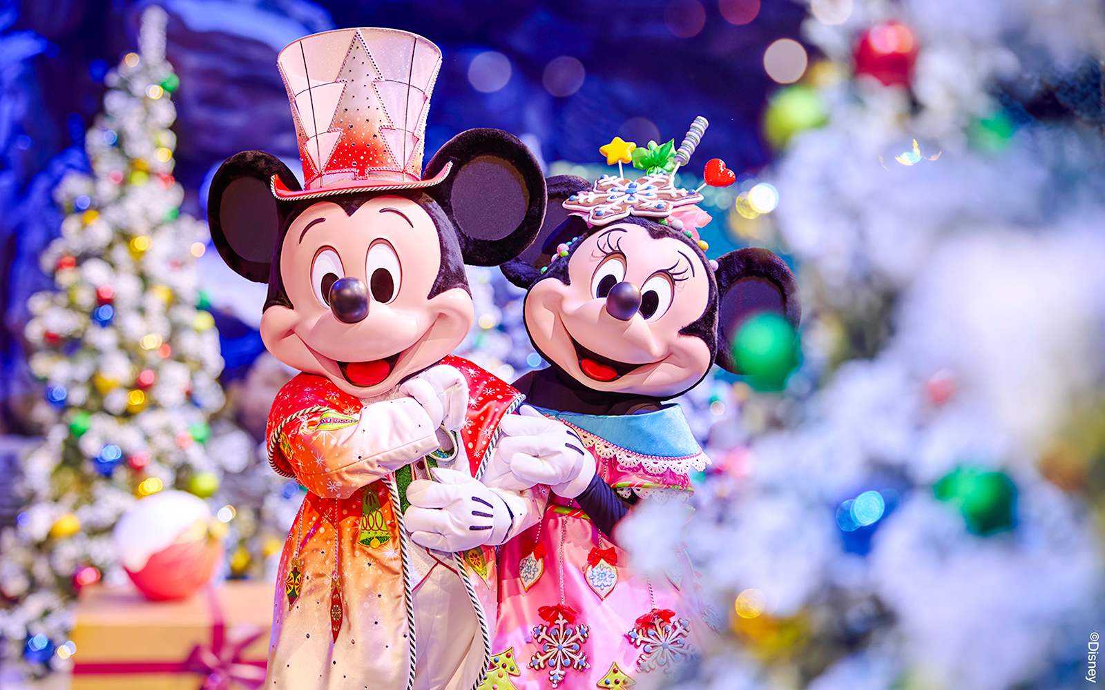 Mickey and Minnie Mouse in festive attire at Disneyland Paris 2025 Christmas celebration.