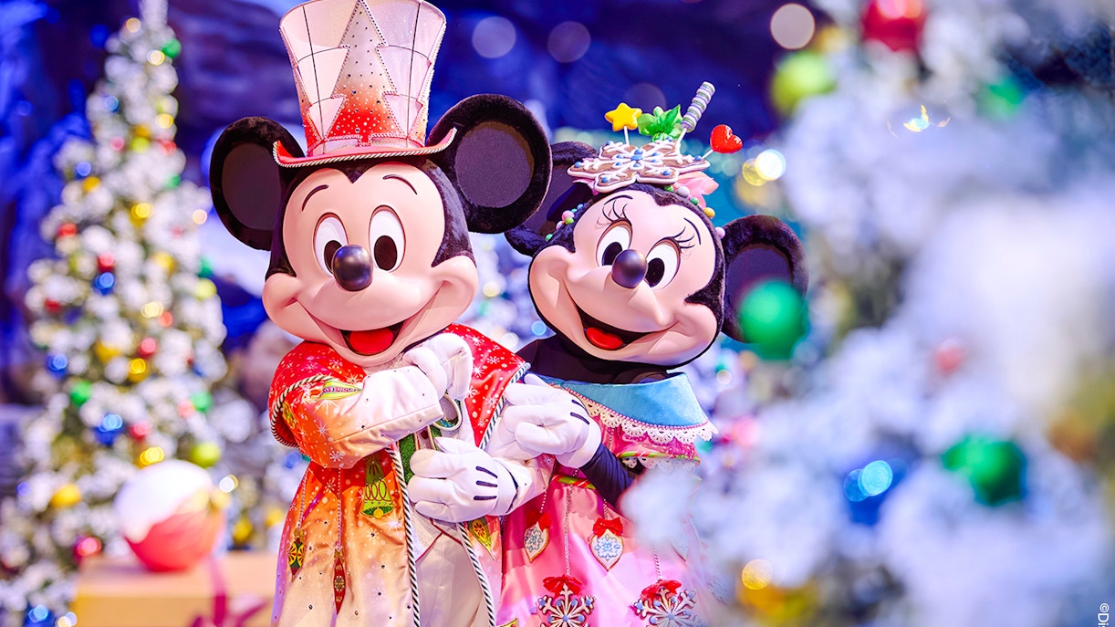 Mickey and Minnie Mouse in festive attire at Disneyland Paris 2025 Christmas celebration.