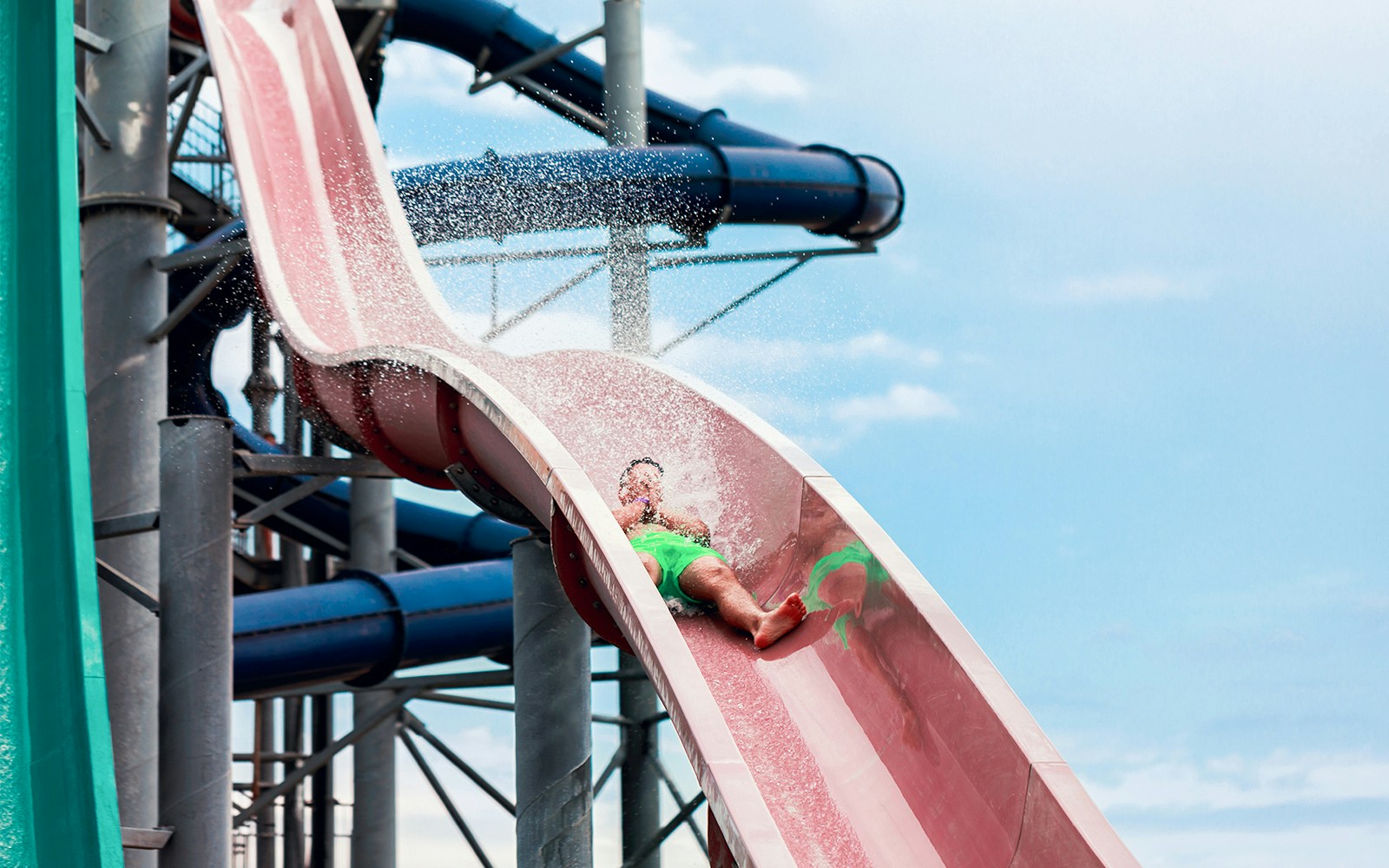 man enjoying on water slide at aqualibi