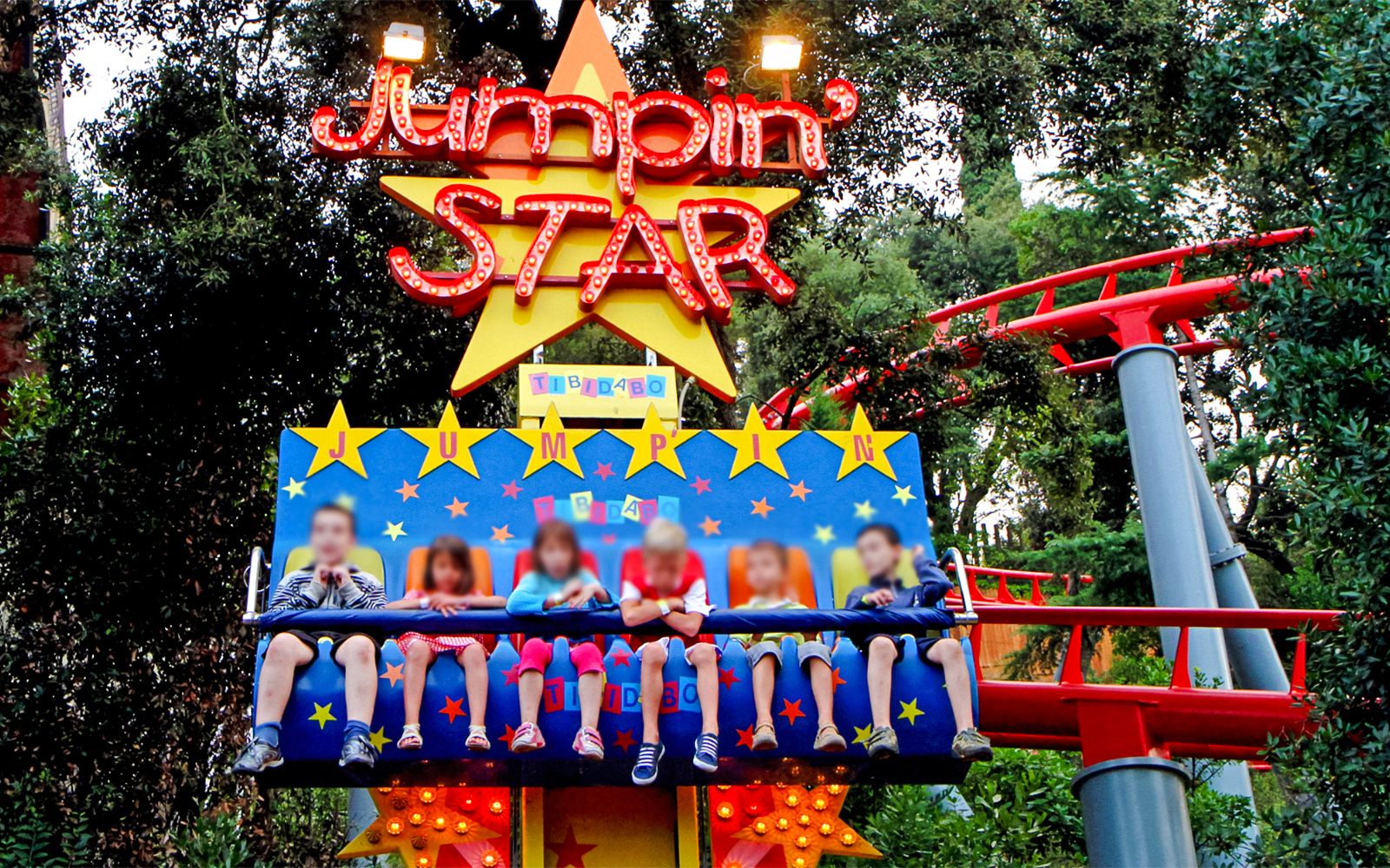 Children on the Granota ride at Tibidabo Amusement Park, Barcelona.