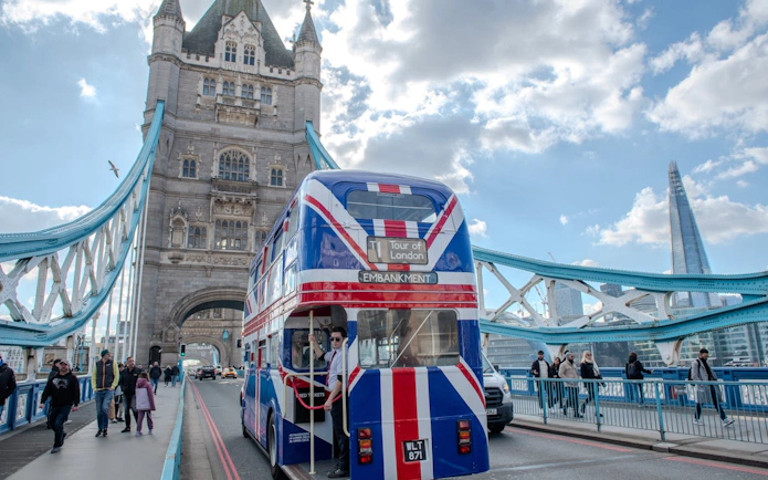 Double-decker bus on Tower Bridge, London, during afternoon tea tour.