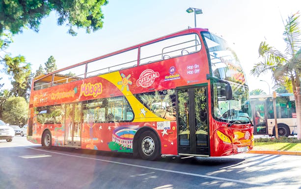 City Sightseeing hop on hop off bus touring Malaga street.