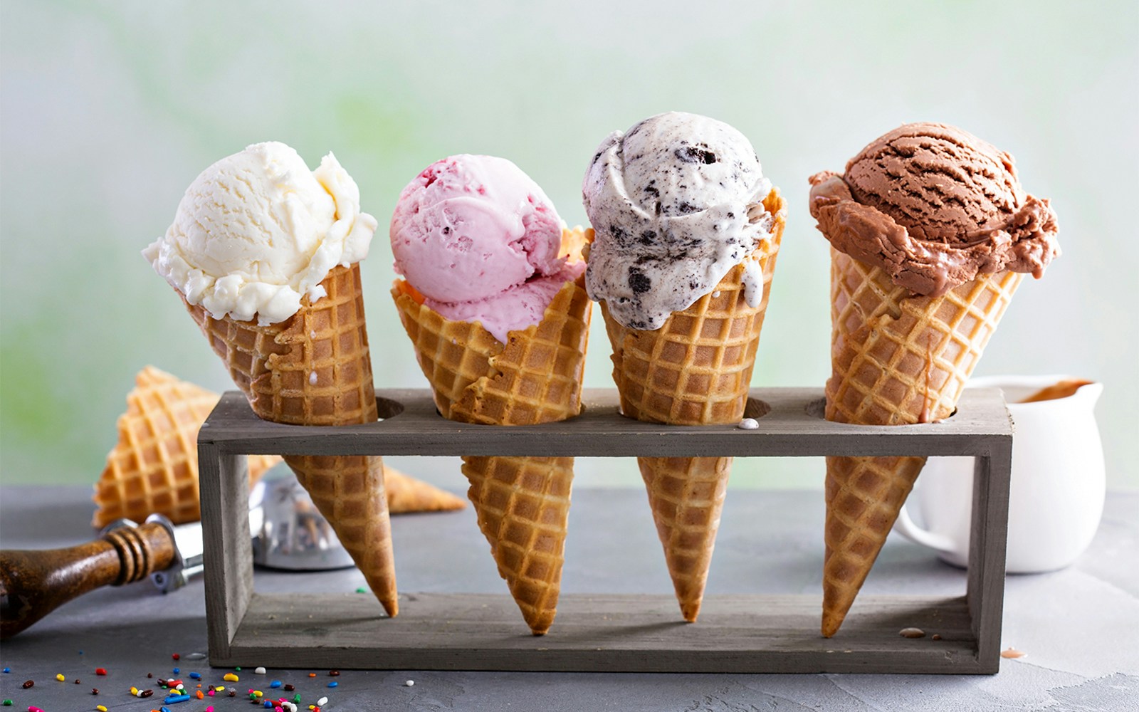 Three ice cream cones with different flavors in a row, showcasing a popular treat in Rome, Italy.